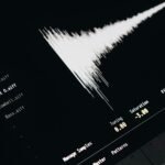 Close-up of a digital audio editing interface displaying sound waves and file names.
